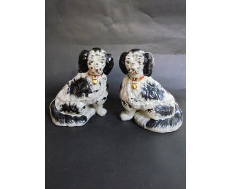 A pair of French ceramic mantel dogs, 24cm tall 