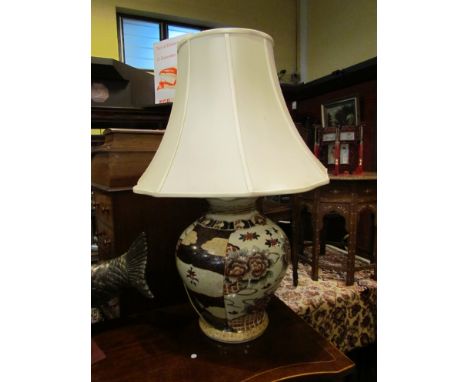 A large bulbous form table lamp, cream ground with Oriental Peony decoration with tube lined  with cream silk shade, 88cm tal