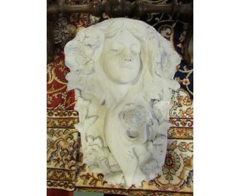 An Art Nouveau style composite plaque of a maiden amongst a foliate surround, 38cm tall