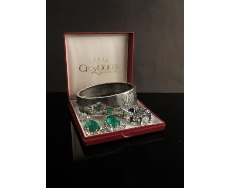 A silver engraved stiff hinge bangle, two pairs of Art Deco style paste drop earrings and bracelet