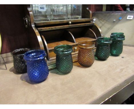 Seven Victorian coloured glass tea light holders 