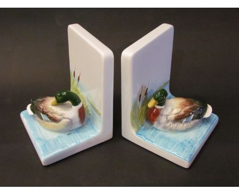A pair of handcrafted ceramic bookends with applied figures of mallards in bulrushes 