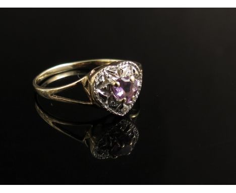 A 9ct gold heart shaped ring in white amethyst and white stone 