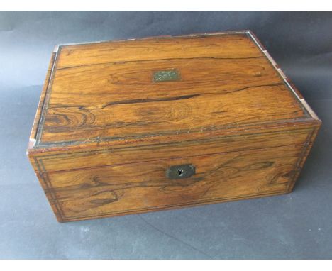 A 19th Century rosewood sewing box with fitted interior and mother of pearl reels, veneer a/f