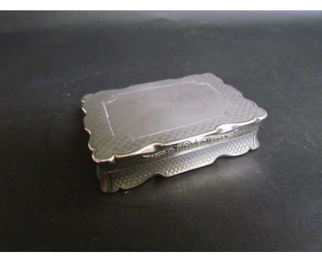 A Nathaniel Mills Victorian silver box with engine turned crosshatch design, vacant cartouche shaped rim, gilt interior, Birm