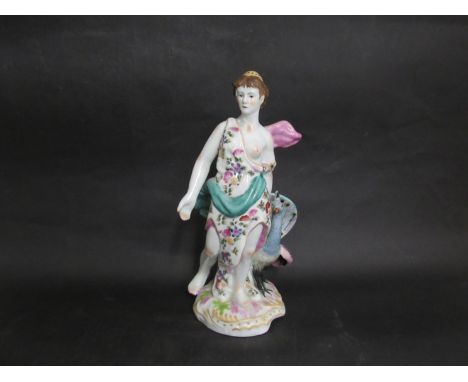 A ceramic figure of lady with peacock, 25cm tall