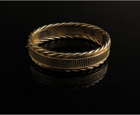 A Victorian stiff hinge bangle, ribbed centre edged and rope twist, in original case