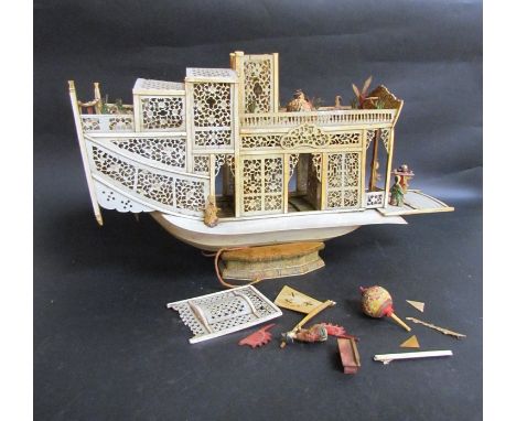 An Oriental carved bone model of a boat with figures on deck, restoration needed