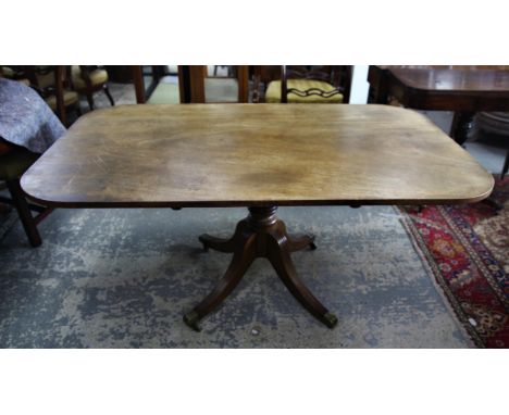 19th century mahogany snap top centre table, the rectangular top on a ring turned stem and tripod base of reeded legs with br