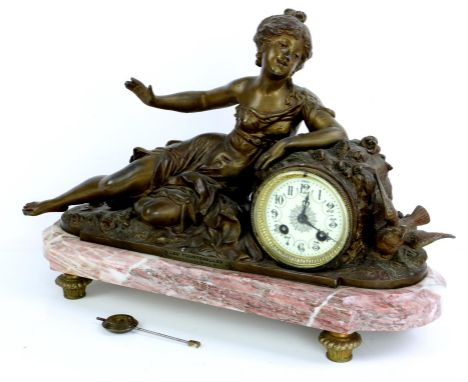 Early 20th century mantel clock cast in spelter as a reclining, the two train movement striking on  a bell