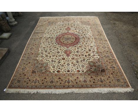 Persian carpet, the red medallion on an ivory field with allover floral design within a beige border, 431 x 298 cm