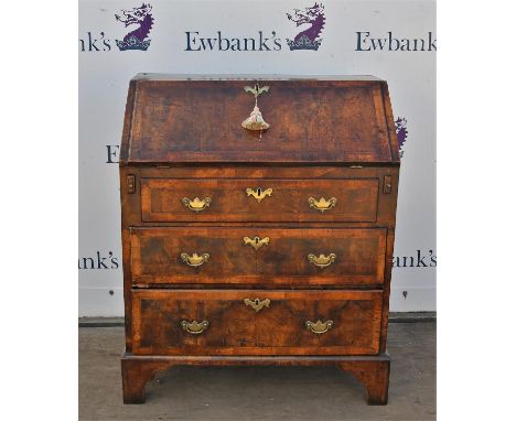 George III walnut bureau with herringbone crossbanding, fall flap enclosing cupboard, pigeon holes and drawers, over three lo