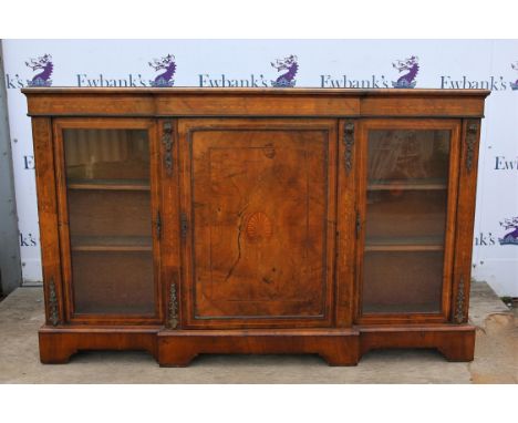 Late Victorian walnut breakfront credenza, the foliate inlaid frieze over an anthemion inlaid central door flanked by glazed 