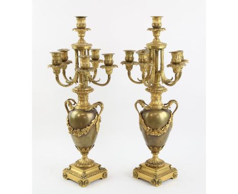 † A pair of French style ormolu Candelabra, each with central candle holder and five branches on urn shaped stems with floral