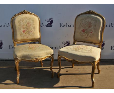 Pair of French style carved and gilt painted chairs with stuffed tapestry backs and seats on carved cabriole legs,