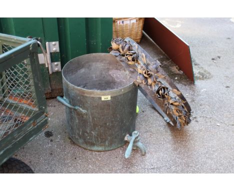A copper pail with tap together with a metal hanging light fitting