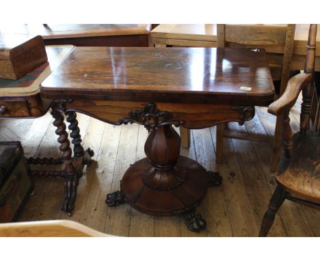 A mid Victorian carved rosewood card table