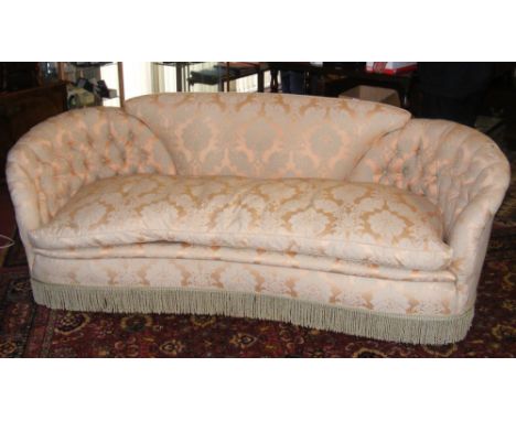 A good quality curved peach damask button upholstered settee with separate loose covers - 235cm wide