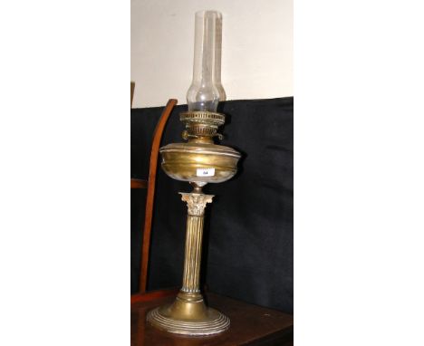 A brass Corinthian column oil lamp complete with chimney