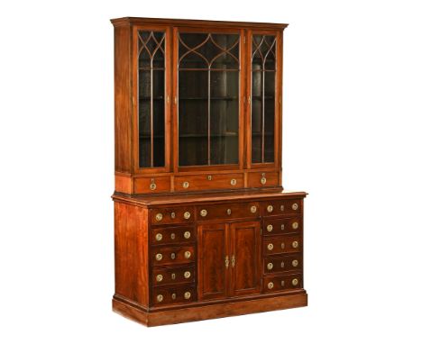 A 19th century mahogany bookcase, in two sections the top half with moulded cornice above a series of glazed doors with drawe