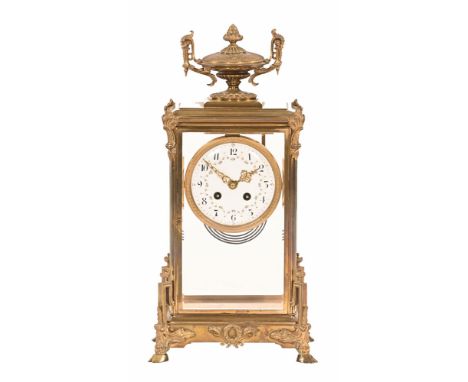 A continental brass four glass mantel clock, with two train movement striking on a gong, the movement marked Mougin Made in F