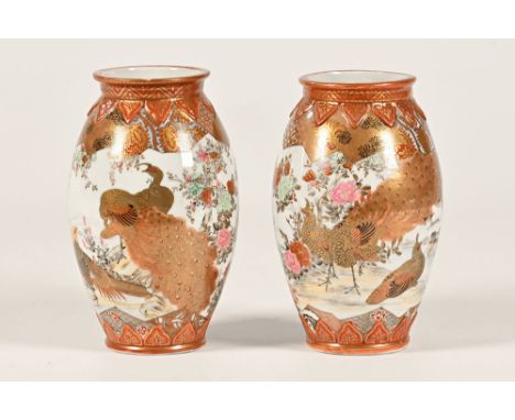 A pair of Kutani vases, decorated with birds to include peacocks, pheasants, geese and with nine character mark to the base o