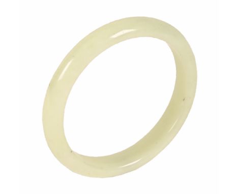 A jade or hard stone bangle, external diameter 8.5 cm, internal diameter 6.5 cm.