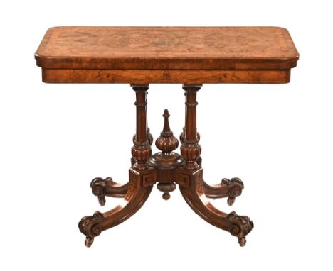 A Victorian walnut turnover top card table, crossbanded and inlaid and with cloth lined playing surface all raised on turned 