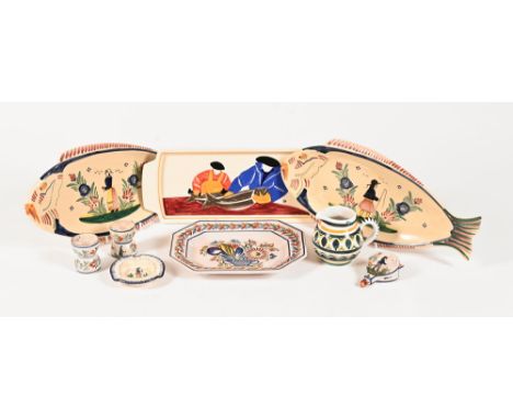 Nine items of Quimper ware, comprising three oblong fish platters +/- 38 cm long, a flower patterned dish, jug, two napkin ri