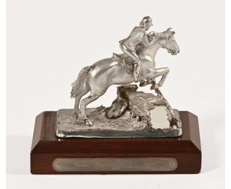 A hallmarked silver cross country trophy, with horse and rider leaping over a wall with silver plaque to the base, Cross Coun