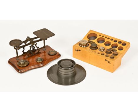 A set of Victorian postal scales and weights, together with a boxed set of gram weights and a pewter inkwell.