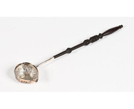 A toddy ladle, the bowl with floral decoration and inset with a coin marked George II, with turned wooden handle.  Overall le