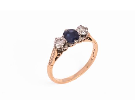 An 18 ct gold sapphire and diamond three stone ring.  Size K/L.