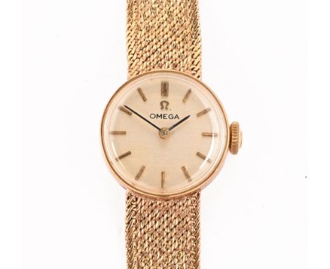 An Omega 9 ct gold cased ladies wristwatch, with 9 ct gold integral bracelet, with champagne dial and baton markers, knob man