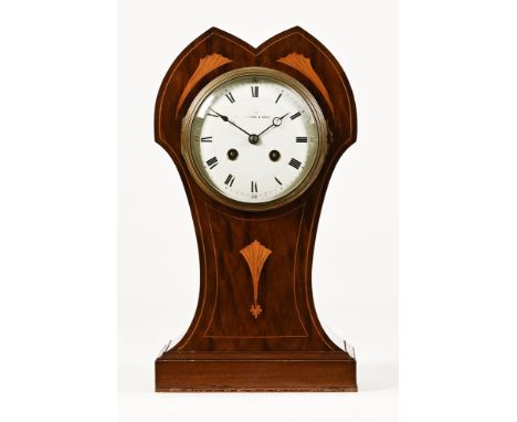 An Edwardian inlaid mantel clock, with double arched top the enamelled dial marked Alford & Sons, the movement marked Made In