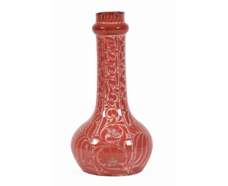 In the manner of William De Morgan a Persian style vase, decorated with a red floral pattern.  Height 35 cm (see illustration