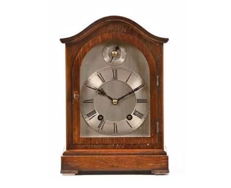 An early 20th century German oak cased mantel clock, with brass dial and two train striking movement by Winterhalder and Hofm