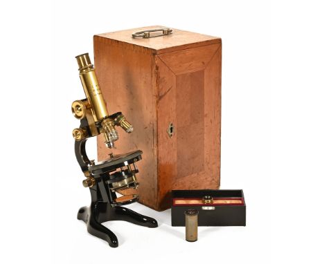 An early 20th century brass and black enamelled monocular microscope by Leitz, Wetzlar. No. 175927 in fitted box with accesso