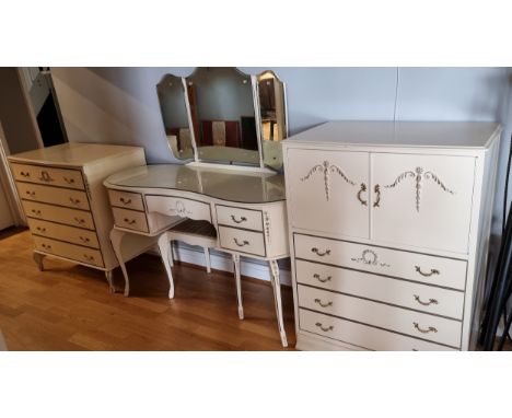 A White painted bedroom suite with gilt decoration comprising of a kidney shaped dressing table with stool, 134 x 51, a chest