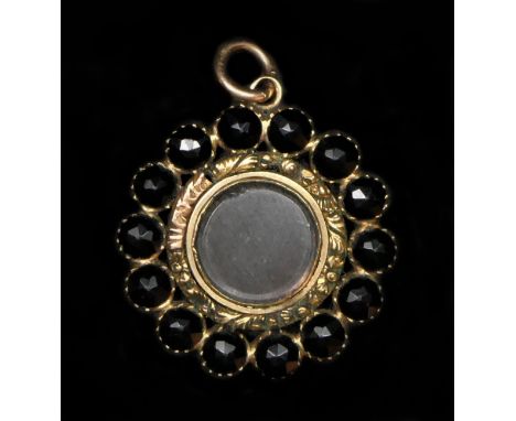 A Georgian gold and facetted jet/black onyx mourning locket pendant, with engine turned decoration to one side and locket the