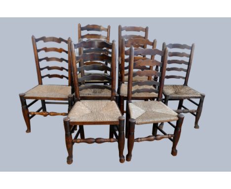 An 18th century matched set of eight (6 + 2) oak ladder back chairs with rush seats.Sold with a photocopy receipt from Cooper
