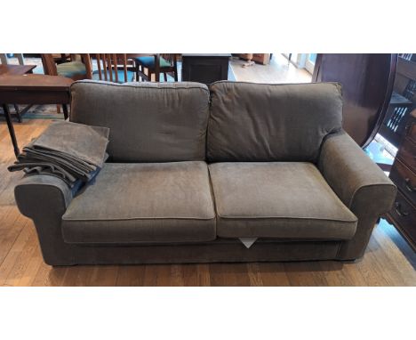 A modern three piece suite, comprising of a three seater sofa and two matching armchairs, upholstered in a light brown chenil