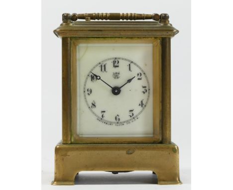 A late 19th century carriage clock by Waterbury Clock Co U.S.A. having brass case and enamelled dial with 8 day stamped movem