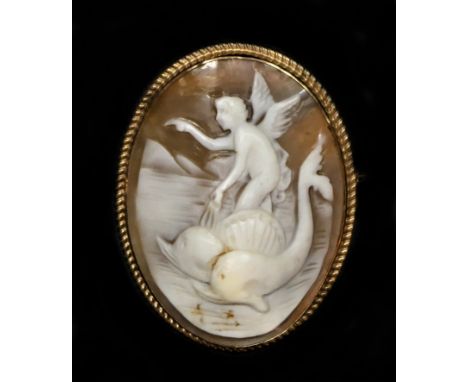 A gold mounted shell cameo, carved to depict Arion riding a dolphin, 43 x 33mm.This subject is inspired by the Roman Ovid's t