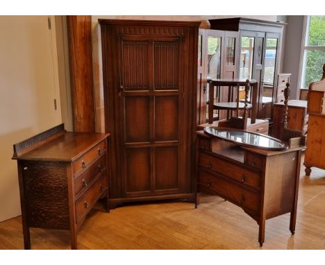 An oak hall robe with linen fold panel door, 96 x 38 x 184cm, an oak dressing table with matching set of three long drawers. 