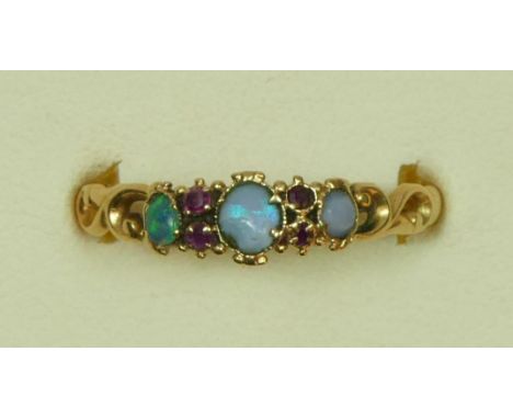 A Victorian unmarked gold opal and garnet ring, scroll shoulders, S 1/2, 1.7gm 