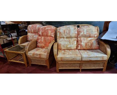 A four piece conservatory suite, rattan design, consisting of a two person sofa, 126cm x 100cm x 95cm, together with two matc