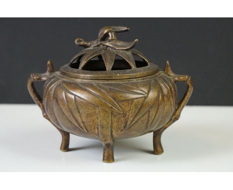 Chinese bronze koro and cover with raised leaf decoration, on four feet 