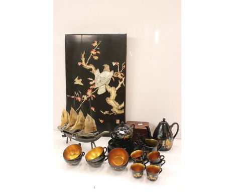 A group of oriental collectables to include tea set, wall plaque, tea caddy and ornamental junk boat. 
