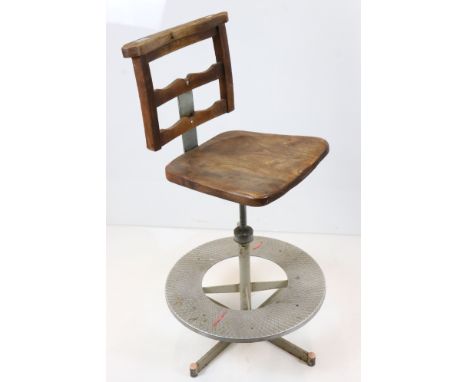 Early 20th century Architect's Swivel Chair, the elm and beech seat held on an adjustable metal base with circular foot shelf